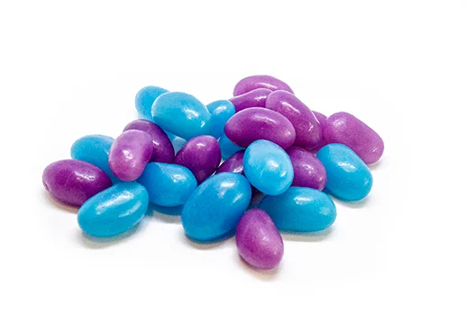 purple and blue jellybeans on white background